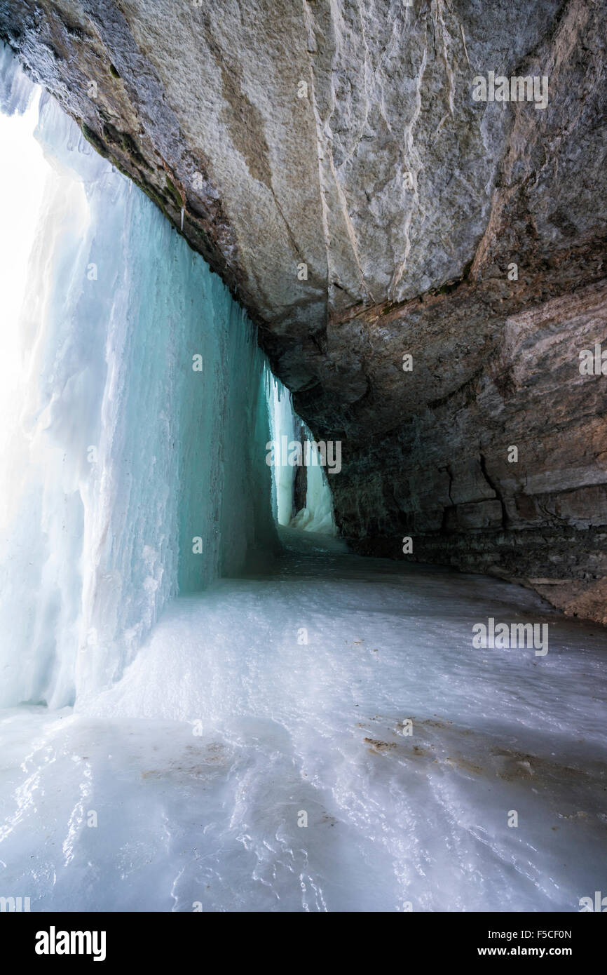 Behind a frozen cascading waterfall in winter, Minnehaha Falls, Minneapolis, MN, USA Stock Photo