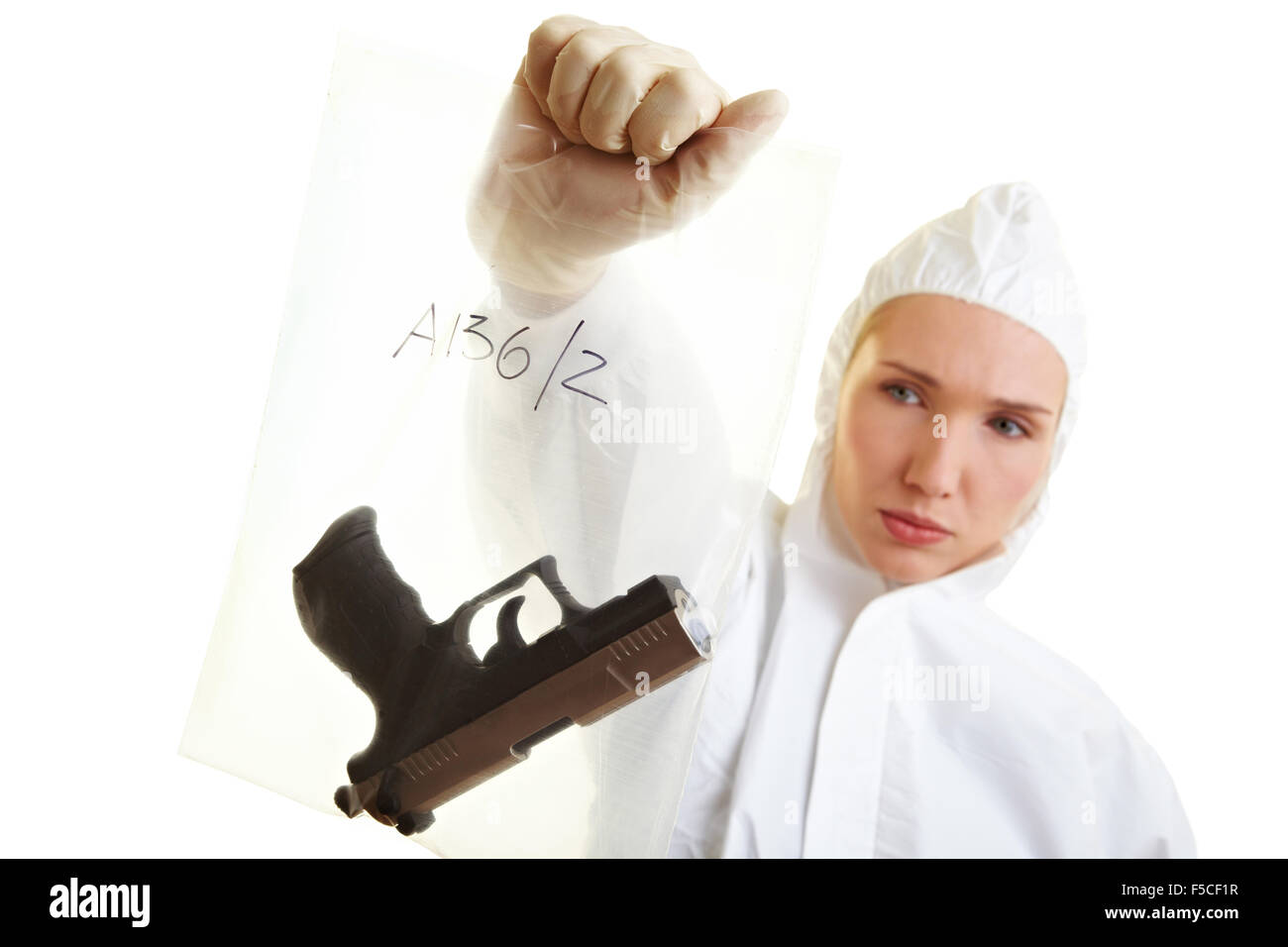 Female forensic scientist holding a weapon as evidence Stock Photo