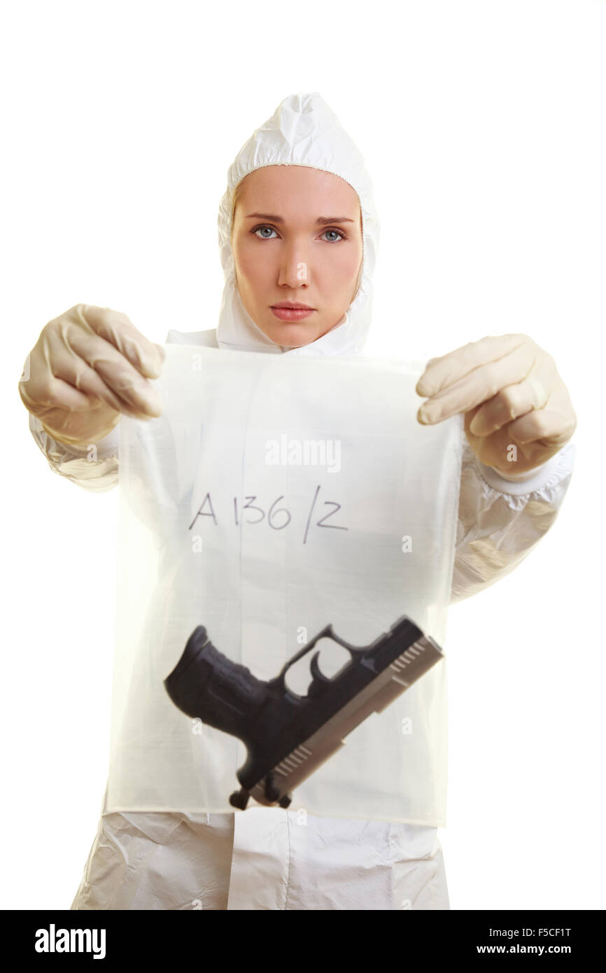 Female forensic scientist holding a weapon as evidence Stock Photo