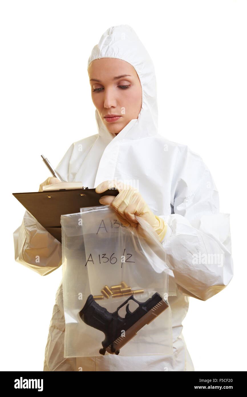 Female forensic scientist holding weapon and ammunition Stock Photo