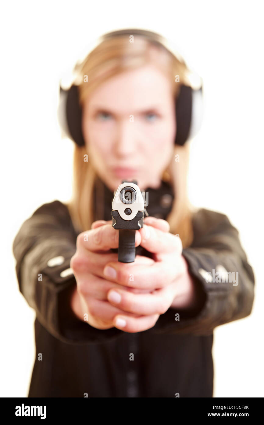 Young female shooter with pistol and ear protection Stock Photo