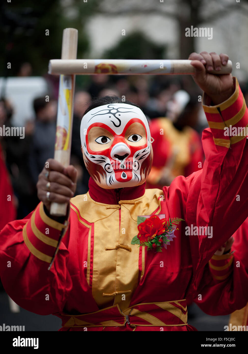 Paris, France - Feb 6, 2011: Chinese performer wearing a monkey mask in traditional costume at the chinese lunar new year parade Stock Photo