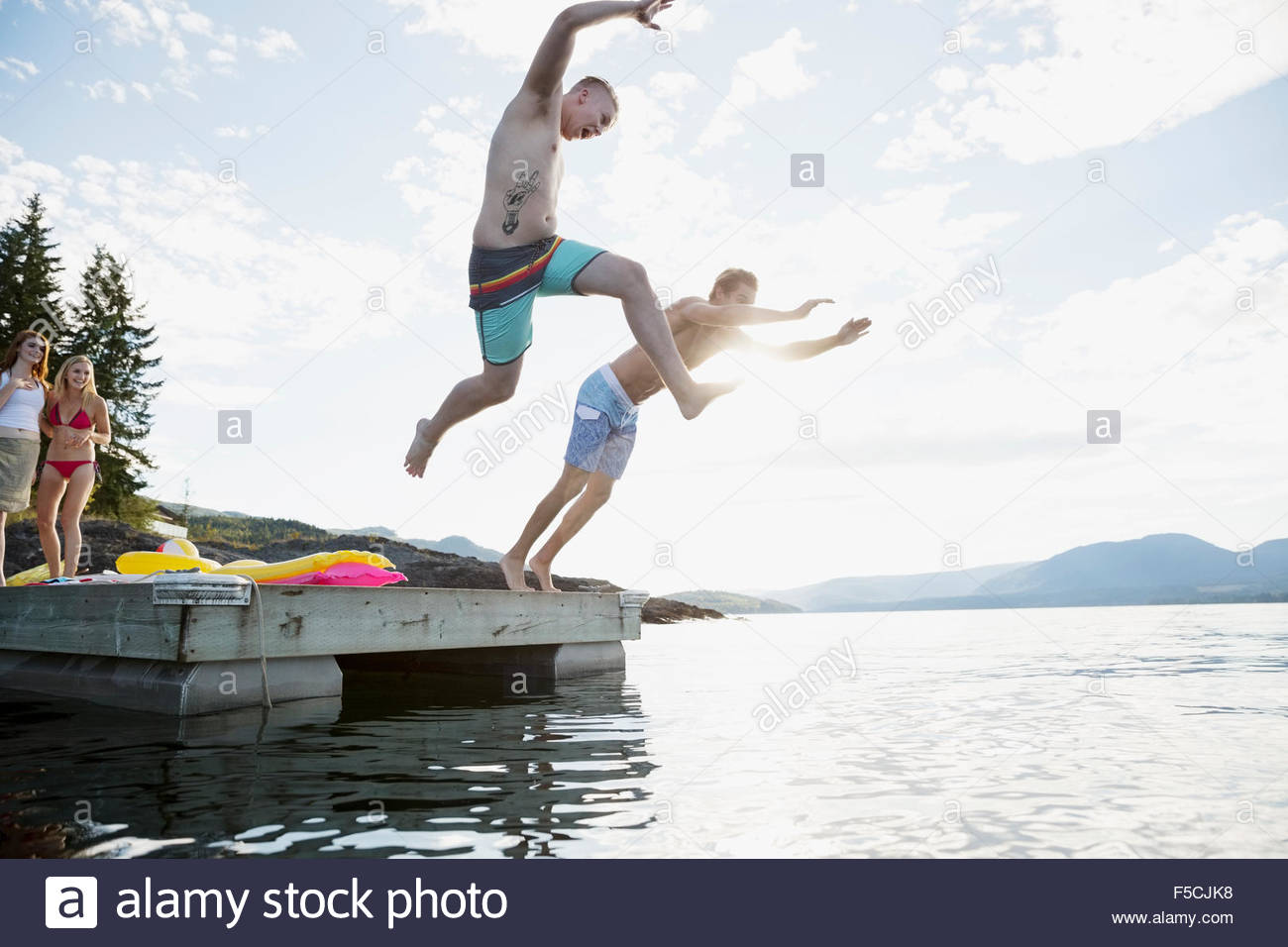 Young Men Jumping From Dock Stock Photos & Young Men Jumping From Dock