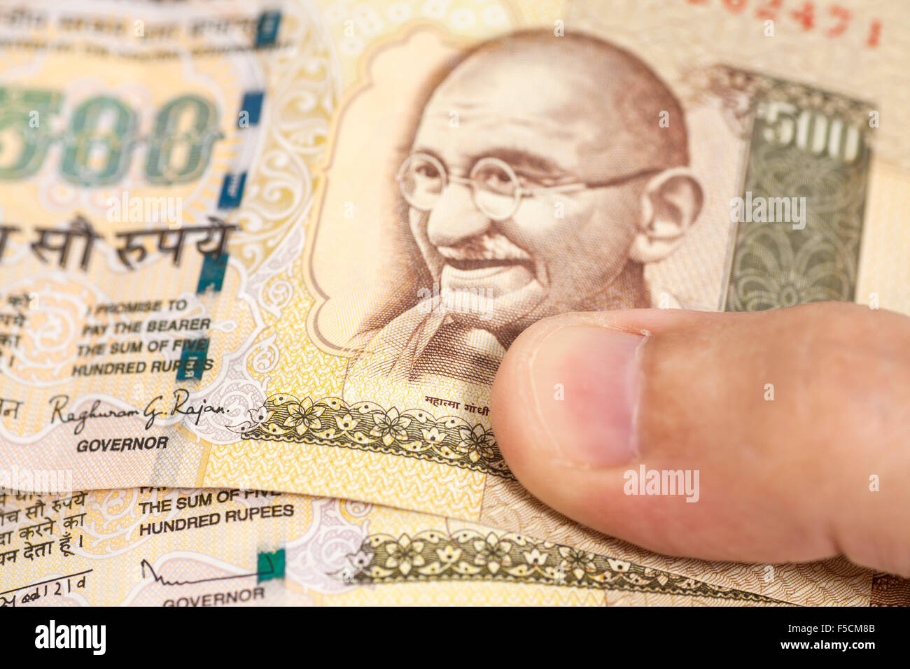 Hand with Indian thousand rupee notes Stock Photo