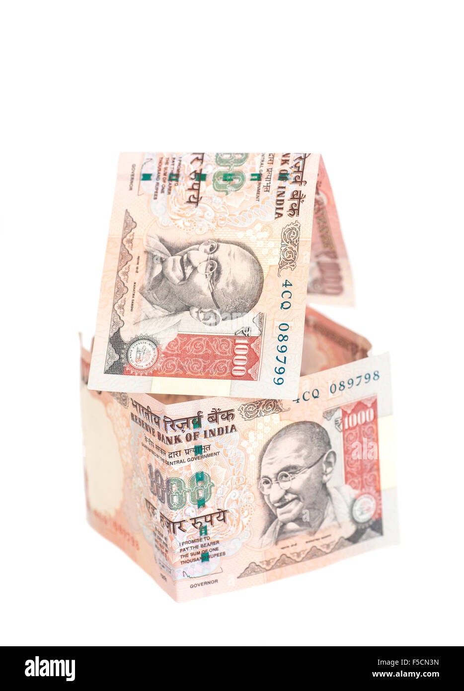 House Made of Indian 1000 rupee banknotes isolated on white Stock Photo
