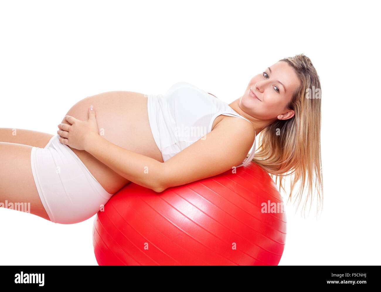 Working out with fitness ball during pregnancy Stock Photo