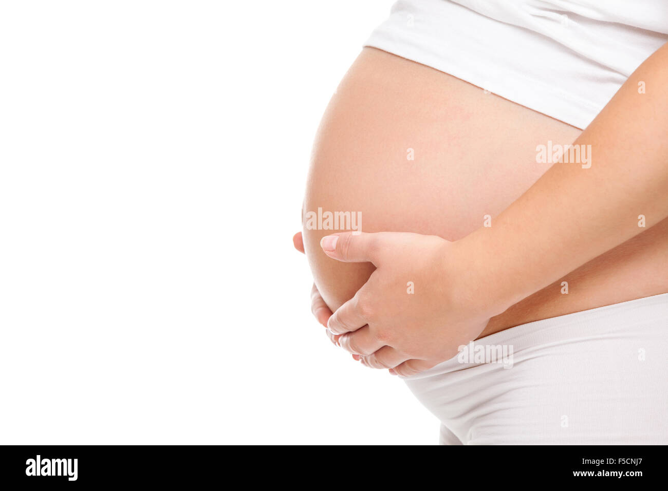 Portrait of a pregnant woman holding her belly Stock Photo - Alamy