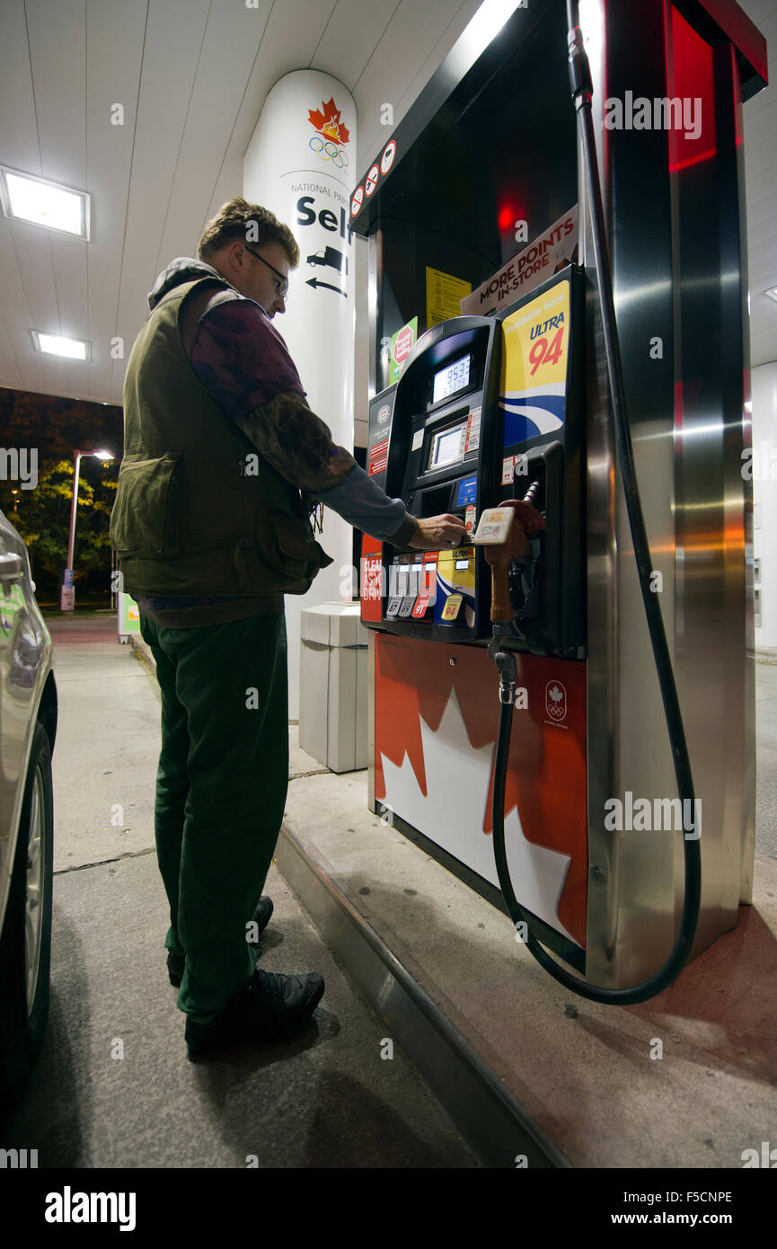 young man filling in the car tank at a gas station Stock Photo - Alamy