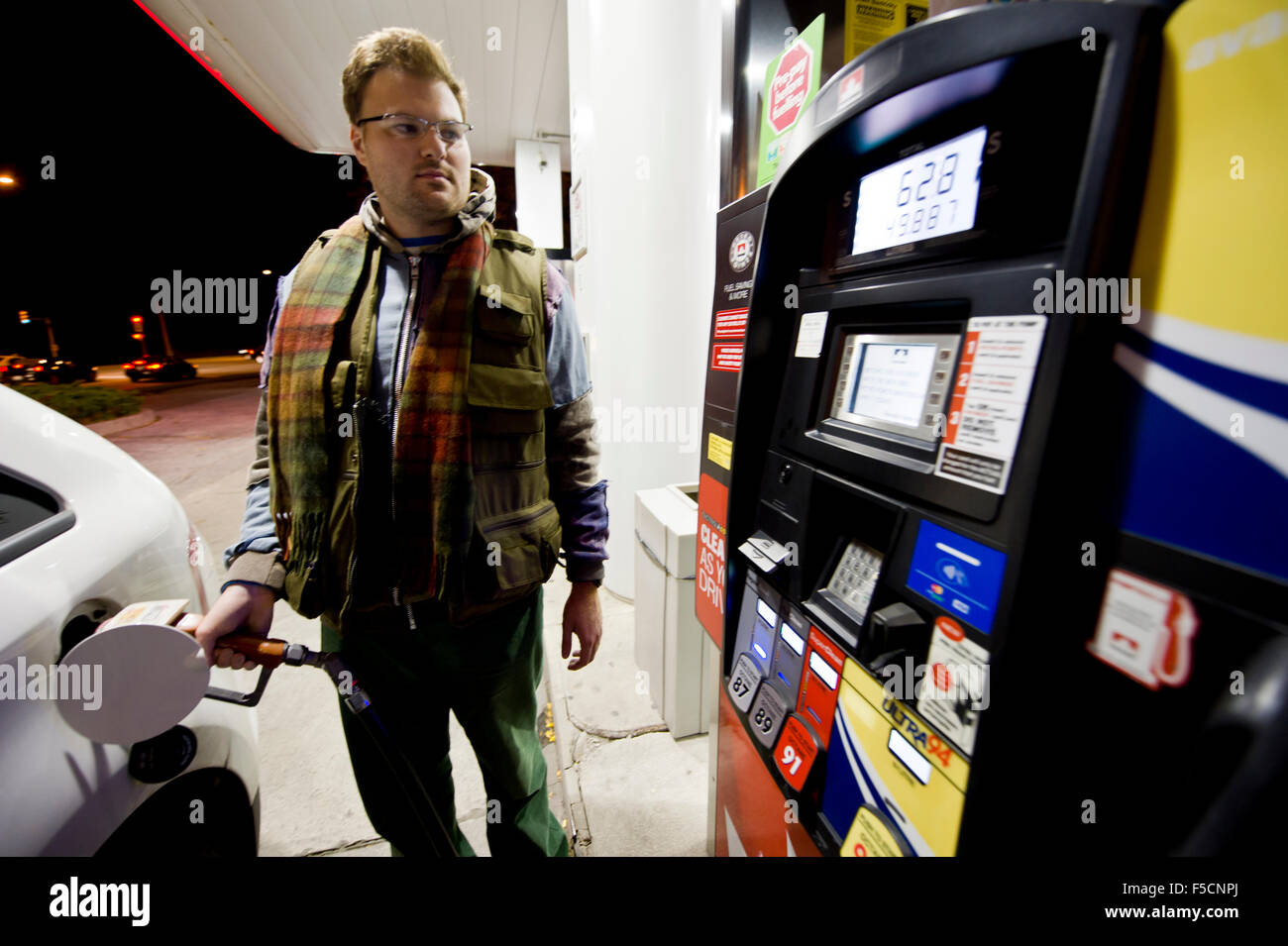 young man filling in the car tank at a gas station Stock Photo - Alamy