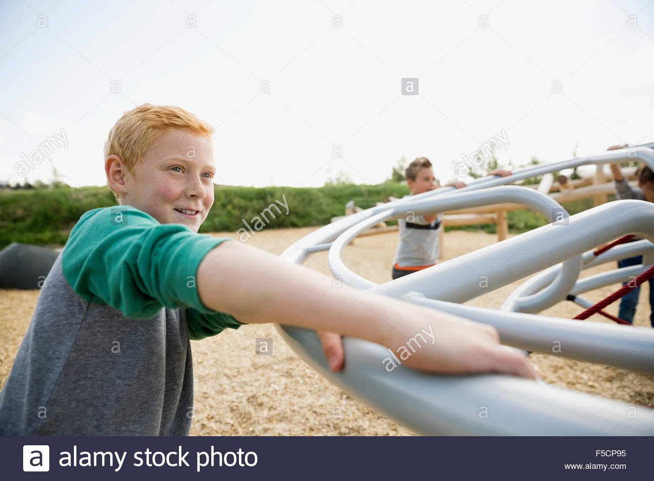 Boy playing with friends at playground Stock Photo
