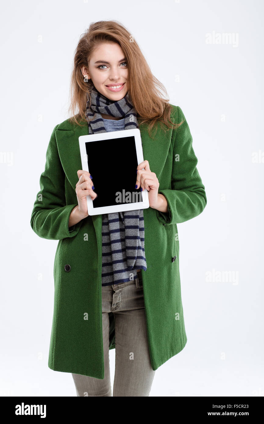 Portrait of a smiling woman showing blank tablet computer screen ...