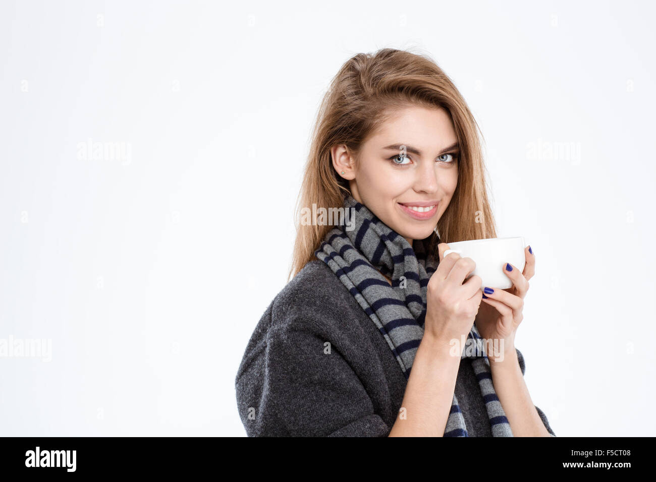 Happy young woman holding cup with coffee isolated on a white ...