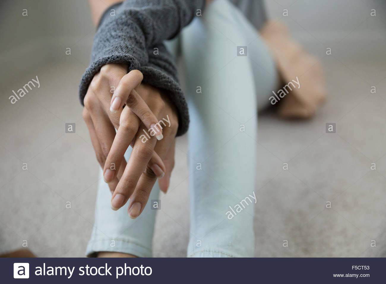 Close up young woman with hands clasped Stock Photo