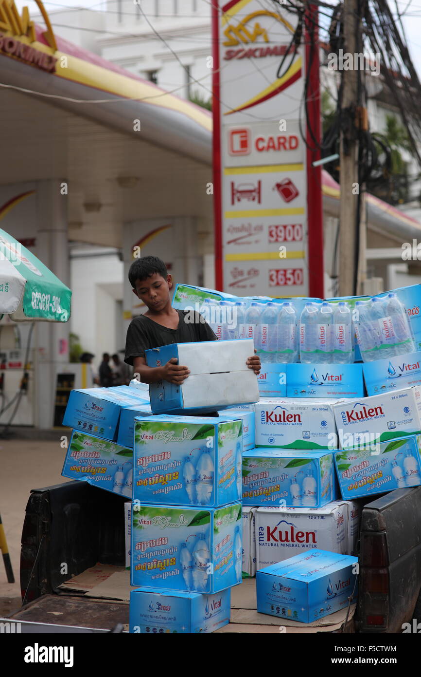 Boy delivering water to petrol station Stock Photo