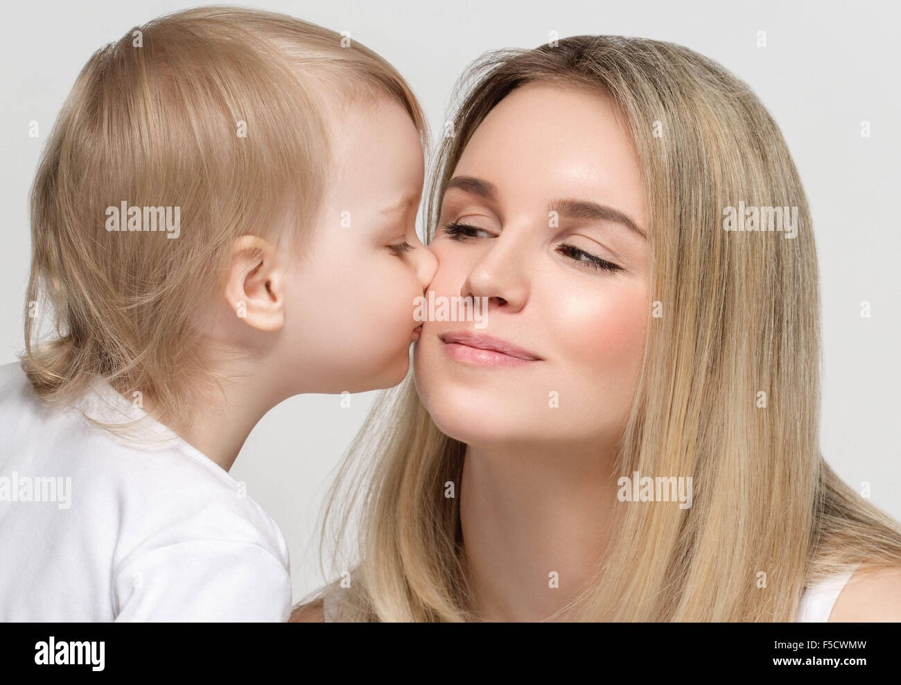 Mother with baby portrait child Woman with blond hair and daughter kiss Stock Photo Alamy