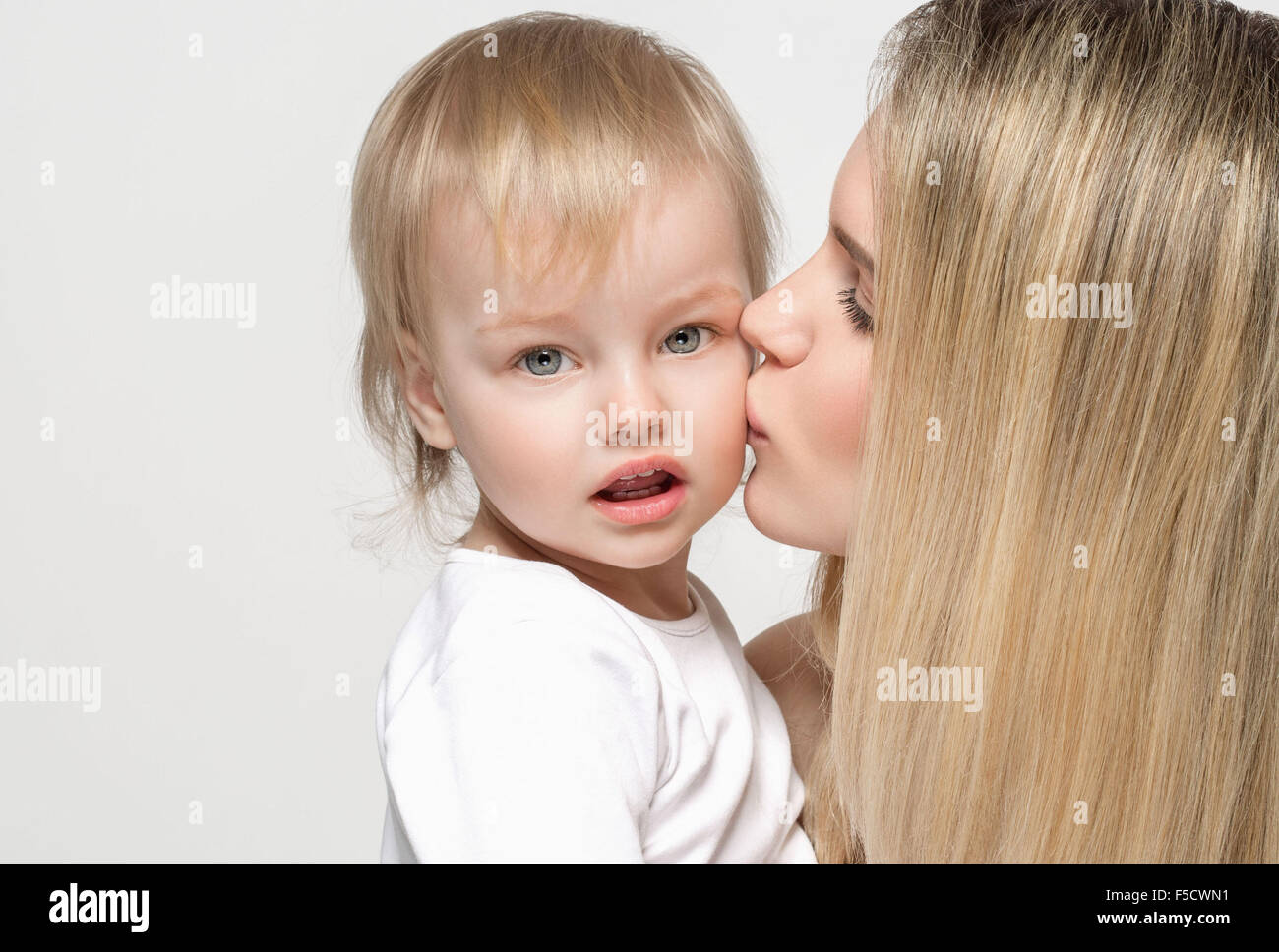 Mother with baby portrait child Woman with blond hair and daughter kiss Stock Photo Alamy