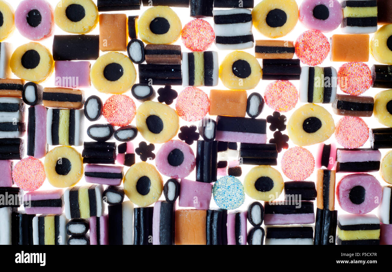 a colourful selection of licorice allsorts sweets on a white back lit background Stock Photo