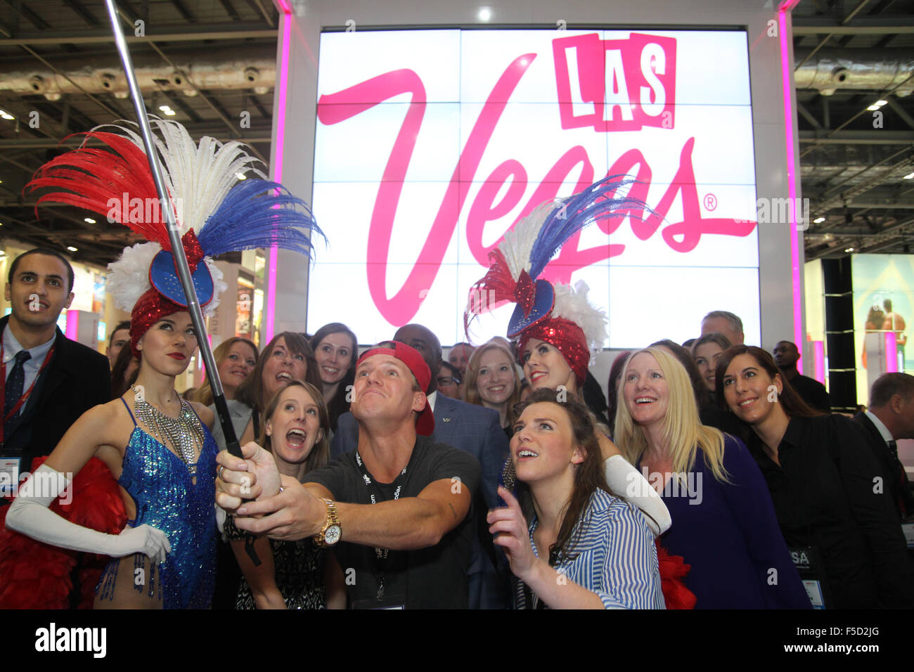 London, UK 2 November 2015. Made In Chelsea's Jamie Laing poses with members of the Las Vegad exhibition stand for a selfie photoshoot at the World Travel Market 2015. Credit:  david mbiyu/Alamy Live News Stock Photo