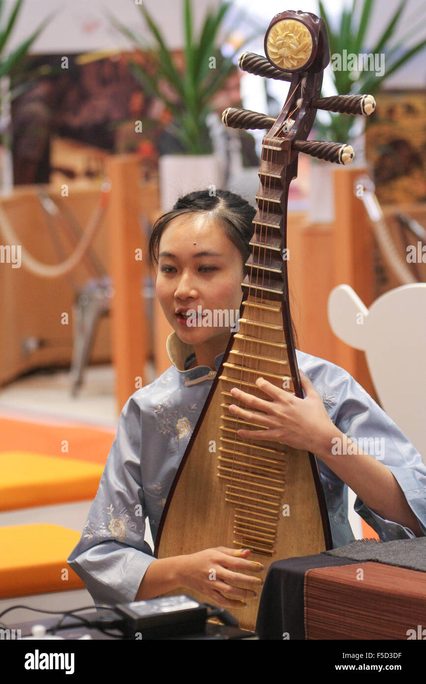 London, UK 2 November 2015. A instrumentalist rehearses for a performances at the Taiwan Tourism stand at the World Travel Market 2015. Credit:  david mbiyu/Alamy Live News Stock Photo