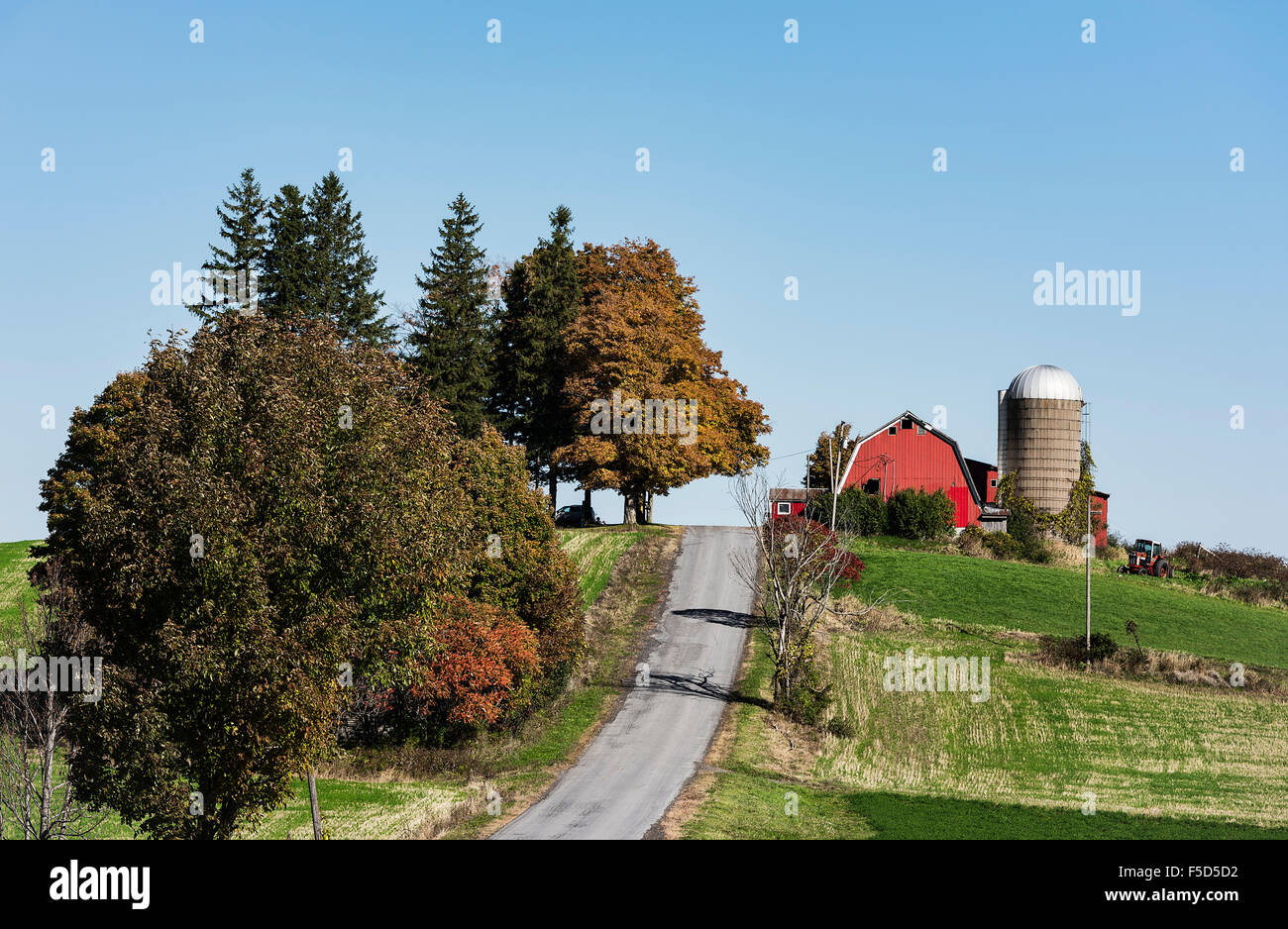 Red barn and silo along a country road, Madison, New York, USA Stock Photo