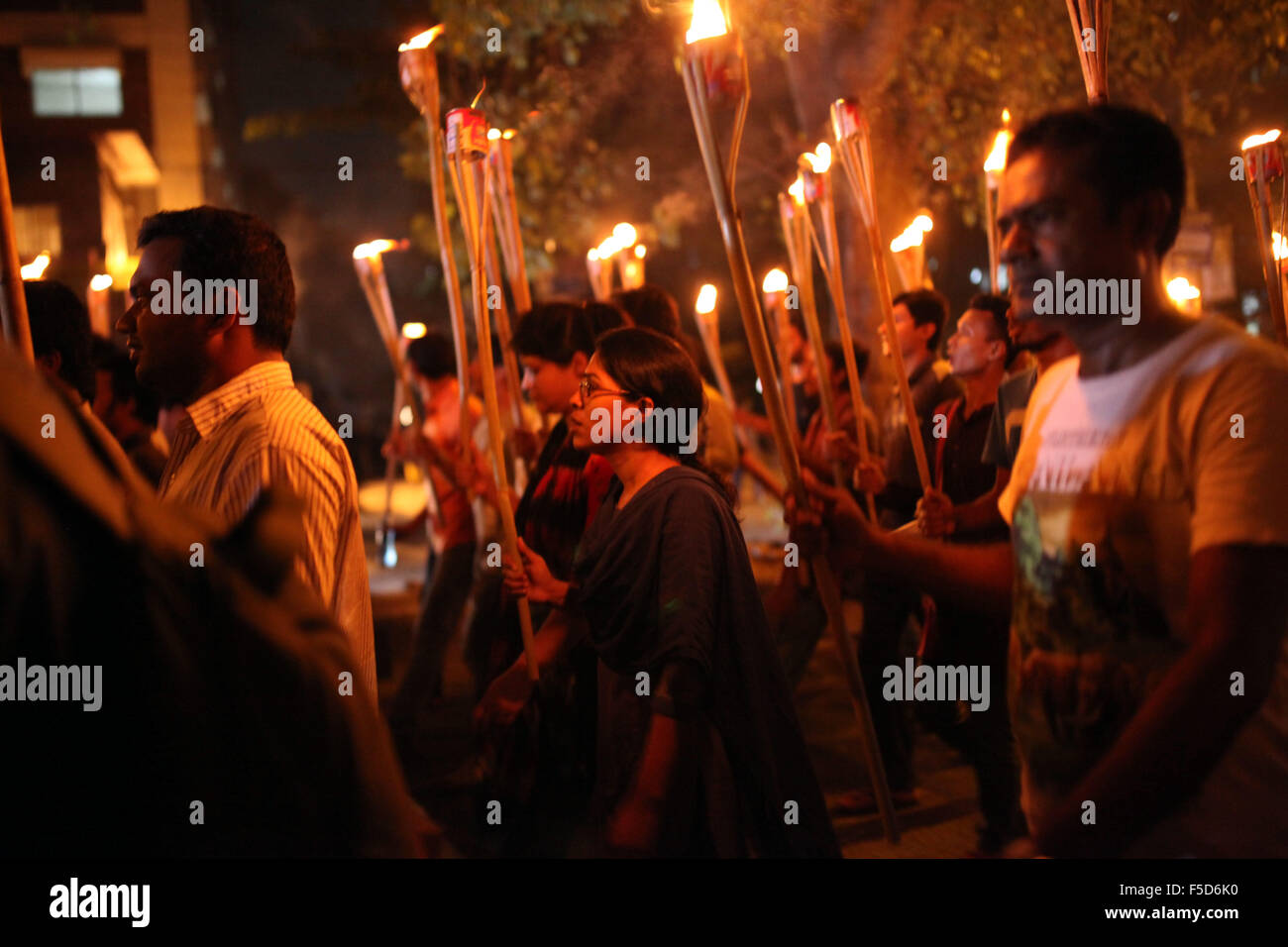 Dhaka, Bangladesh. 2nd Nov, 2015. DHAKA, BANGLADESH 02nd November : Cultural activists, writers and members of the Ganajagaran Mancha shout slogans as they attend a torch light procession protesting the killing and attacks on the publisher and bloggers in Dhaka on November 02, 2015.Ganajagaran Mancha has called for a half-day country-wide strike on 03 November demanding the arrest of the assailants of publishers. The publisher Faisal Arefin Dipan was stabbed to death in Dhaka on 31 October, hours after unidentified assailants knifed another publisher and two secular bloggers elsewhere in th Stock Photo