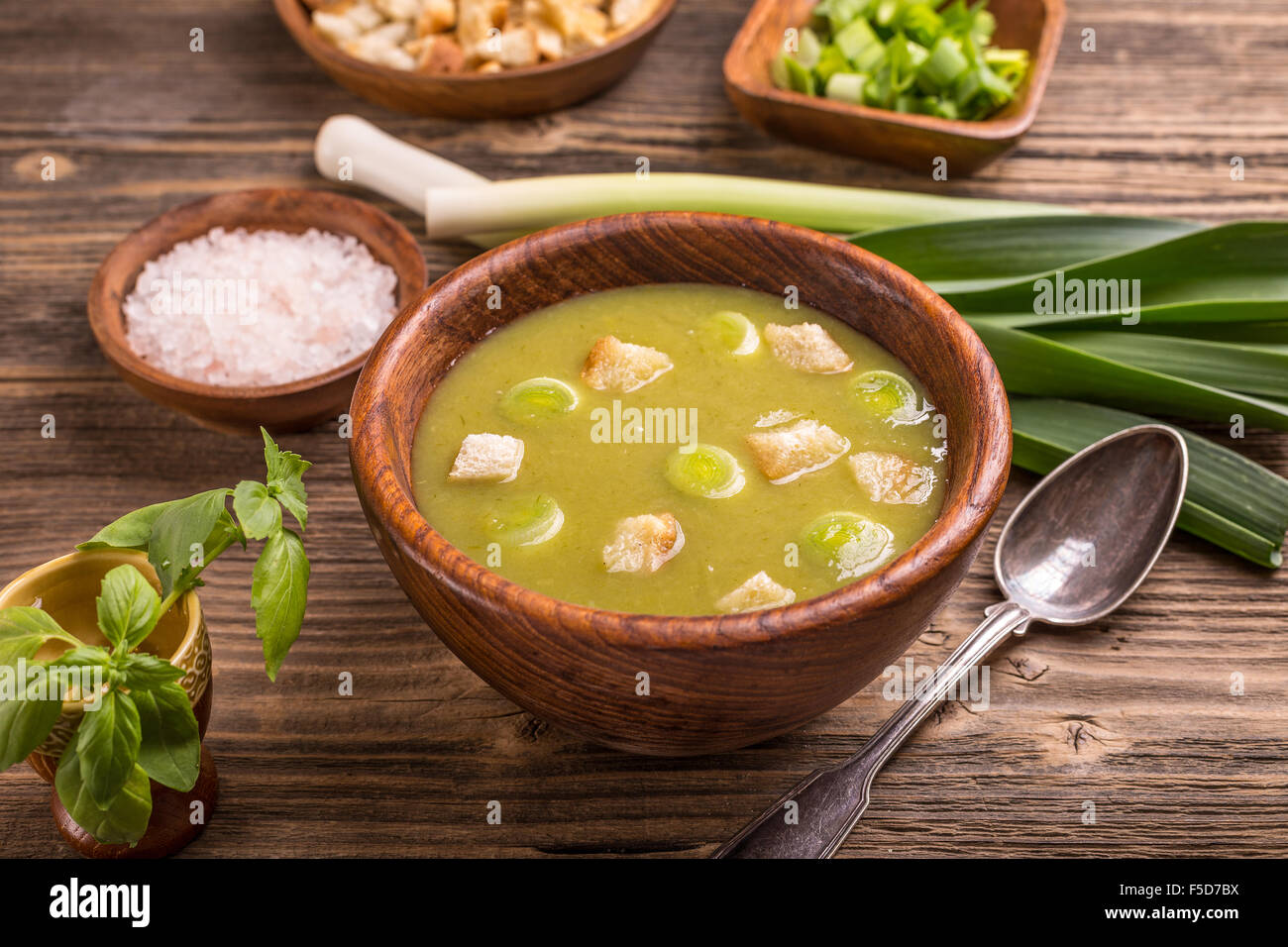 A bowl of leek and potato soup with bread croutons Stock Photo