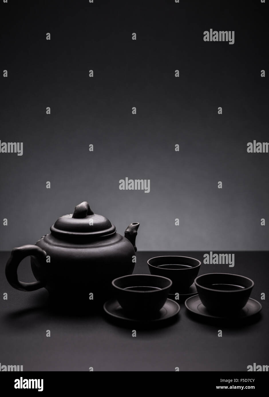Tea set on black background Stock Photo - Alamy