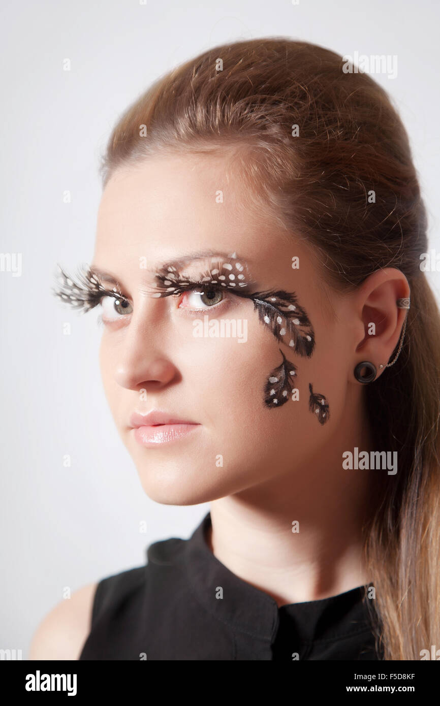 Beautiful woman with big eyelashes and faceart, studio shooting Stock