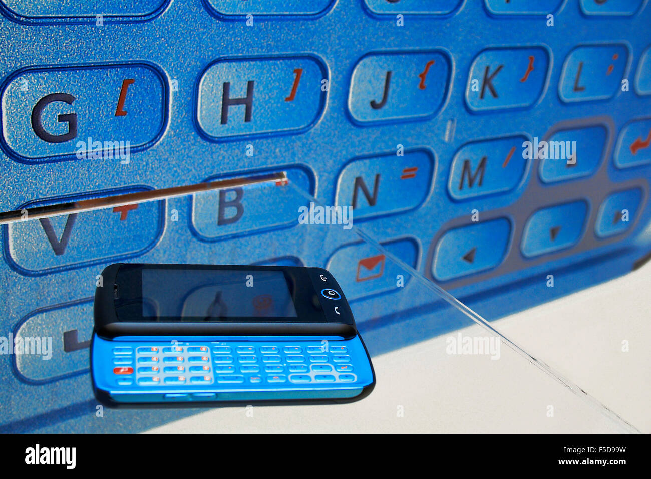 Mobile phone and palmtop against keyboard image with letters and functions Stock Photo