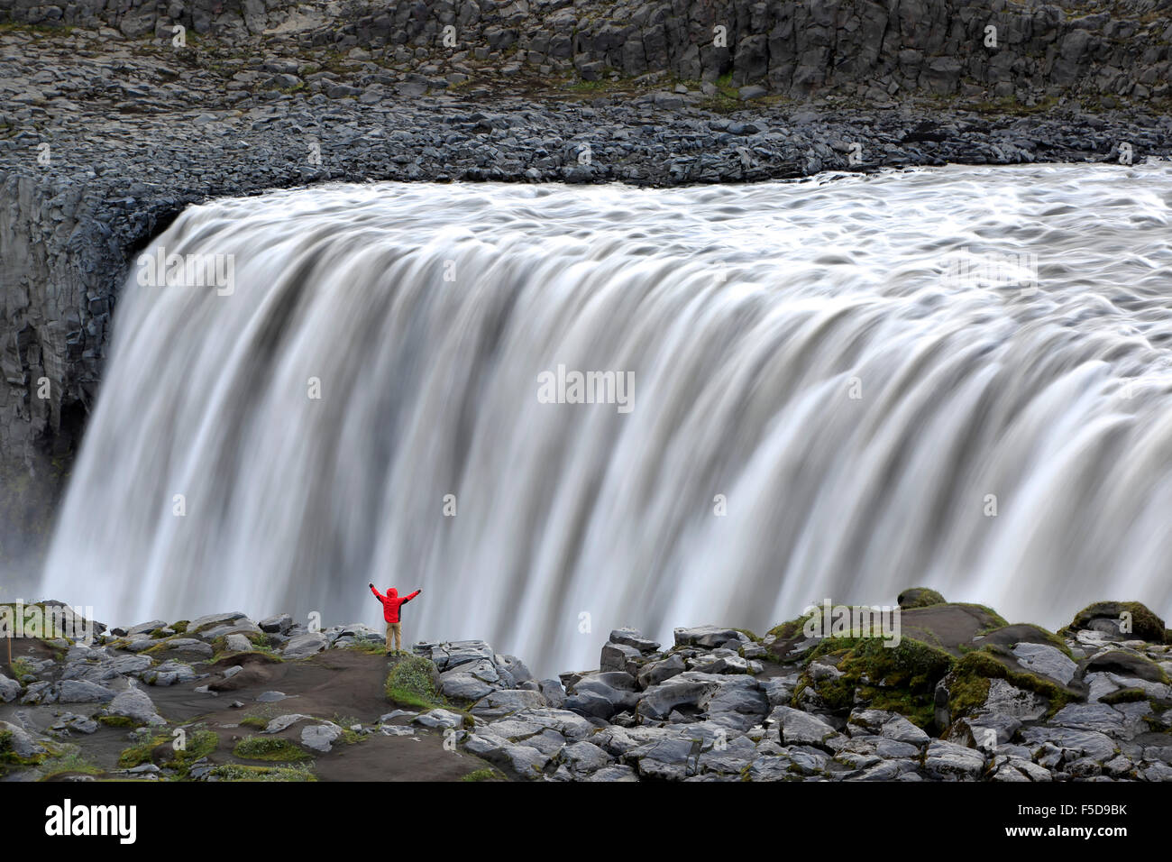 Hiker on rim of Dettifoss Waterfalls, near Reykjahlid, Iceland Stock Photo