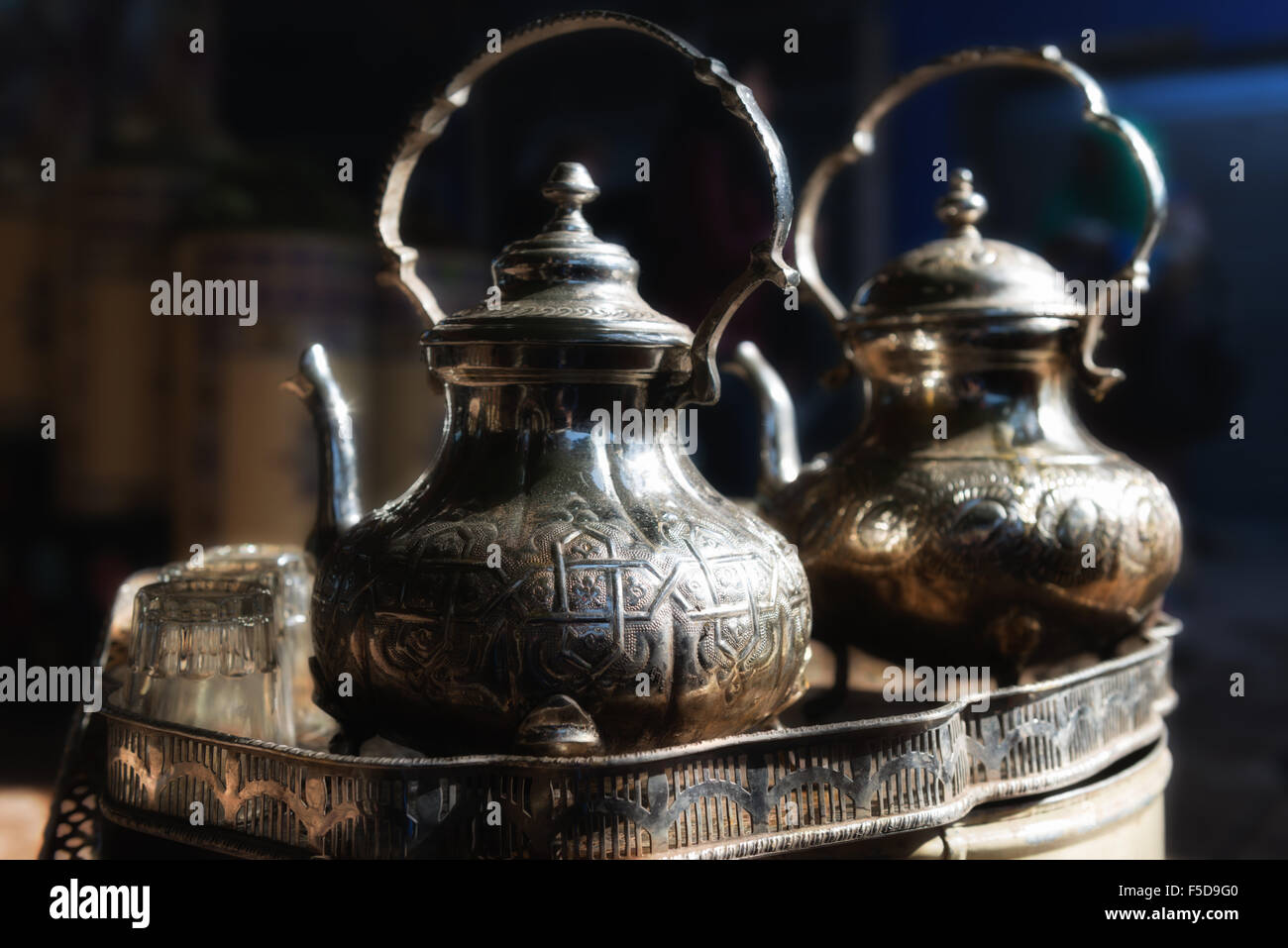 Traditional Moroccan teapot with glasses in a tea tray. Medina of Marrakesh, Morocco. Stock Photo