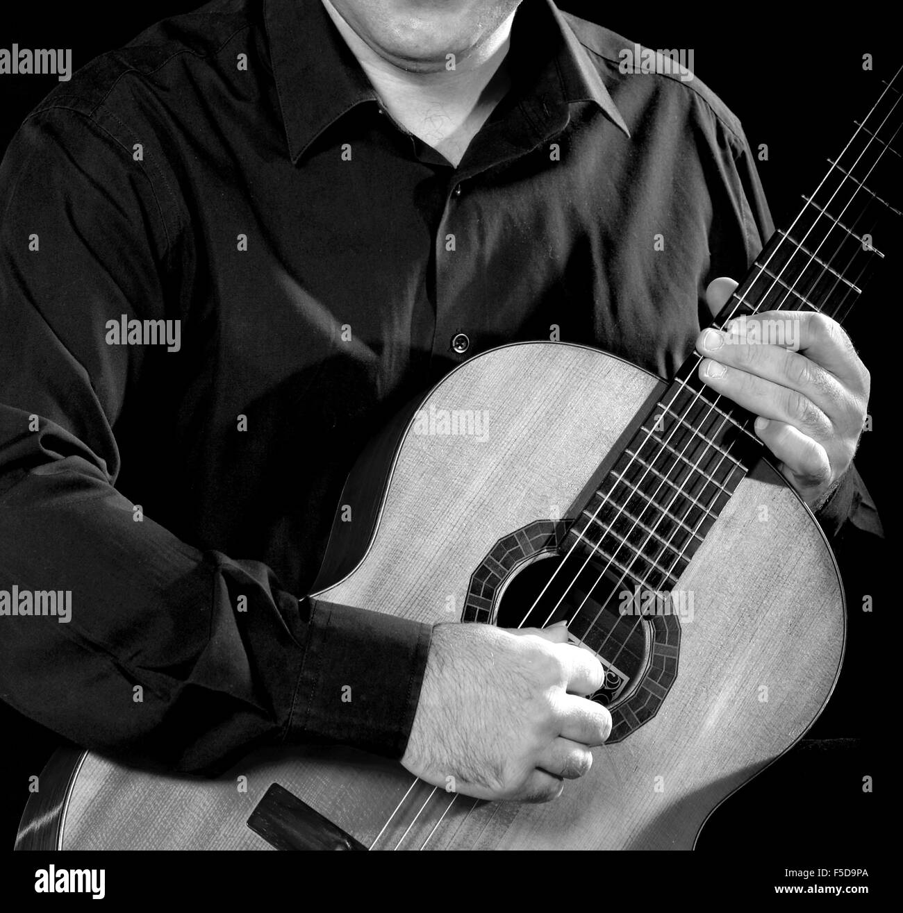 Classical Guitarist low key image square format Unrecognizable person black and white Stock Photo