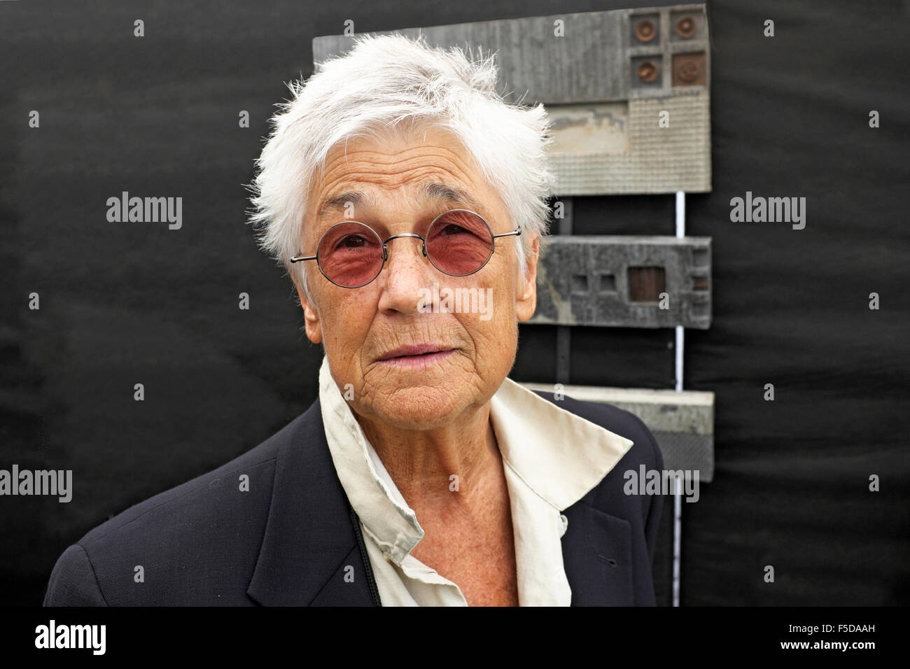 A middle-aged woman with very short hair wearing tinted glasses. she is artist Grayson Malone. Stock Photo