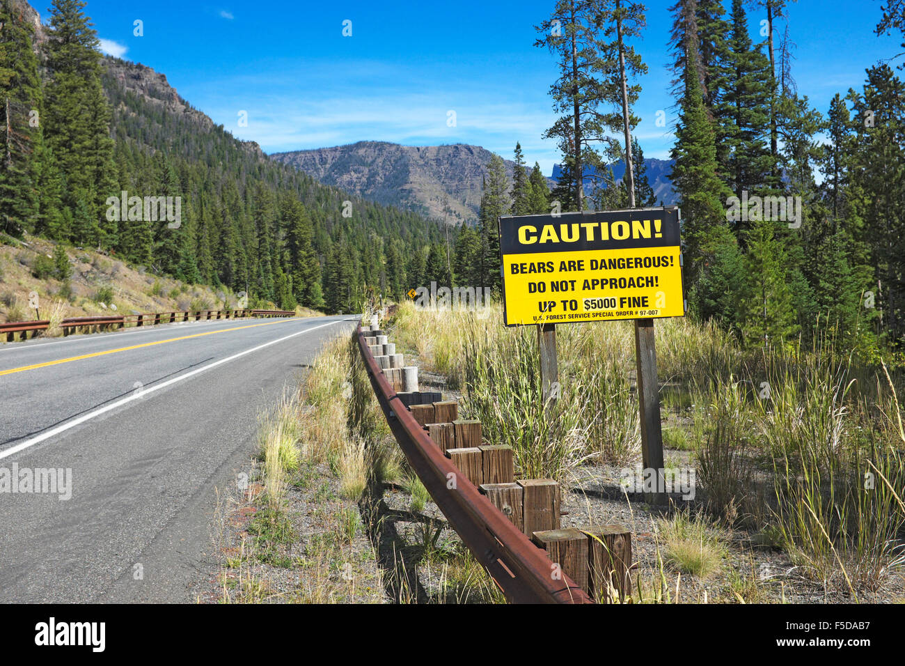 A sign along the North Fork of the Shoshone River in Wyoming, warning campers to be aware that there are grizzly bears nearby. Stock Photo