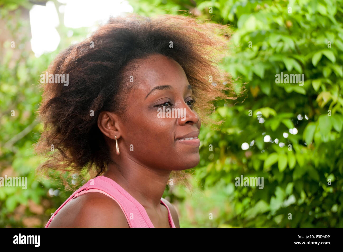 Pretty lady with frizzy hair smiling. Stock Photo