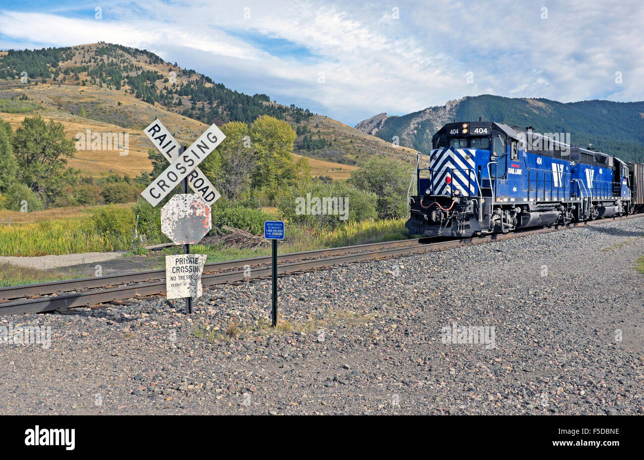 A Raillink work train at a private crossing on the mainline tracks coming into Bozeman, Montana. Stock Photo