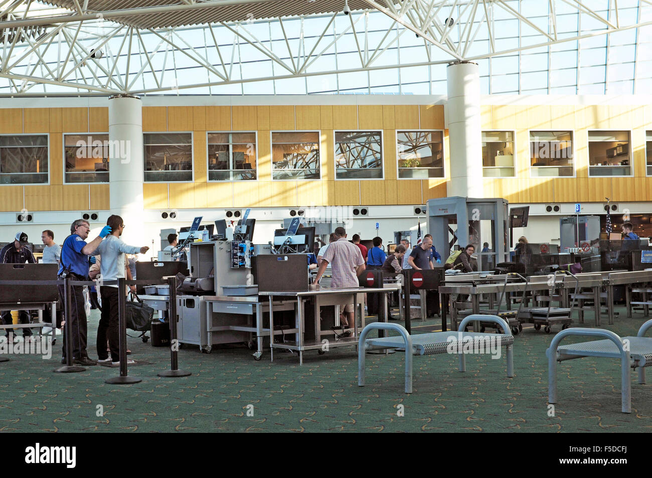 An airline passenger being handsearched by a TSA agent at the Portland