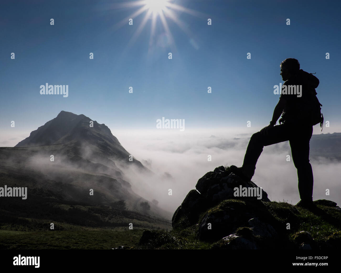 A hill walker looking at a temperature inversion around Chrome Hill in the Peak District National Park Stock Photo