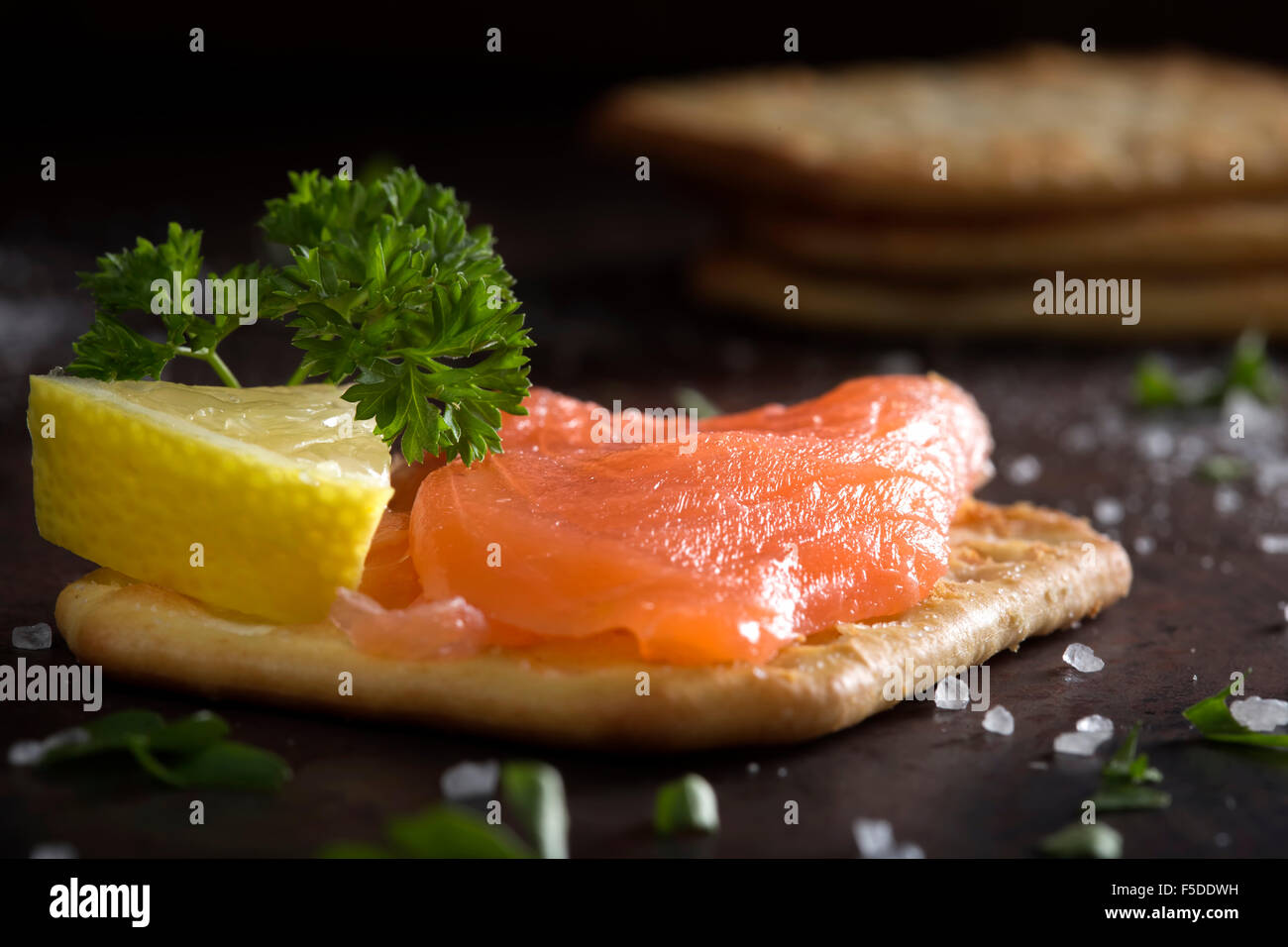 Close-up of smoked salmon served with crackers Stock Photo