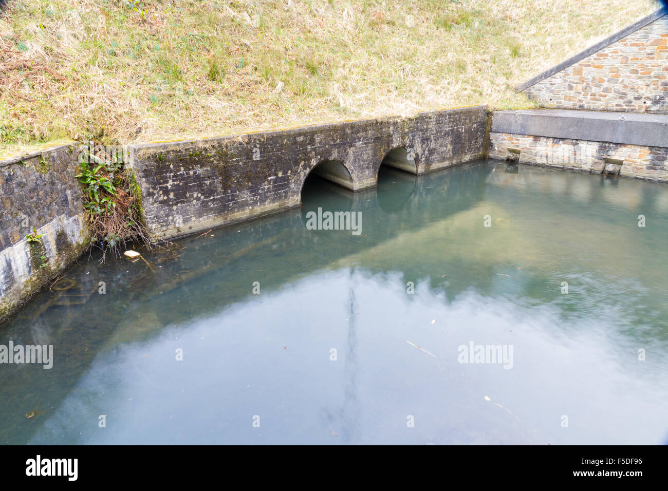 Drainage pipes leading to Resolven Basin, Neath Canal. Resolven, Vale of Neath, Port Talbot, Wales, United Kingdom. Stock Photo