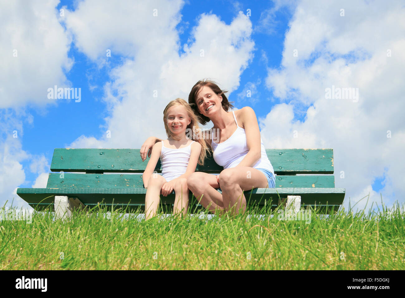 woman with his child sitting on the bench Stock Photo