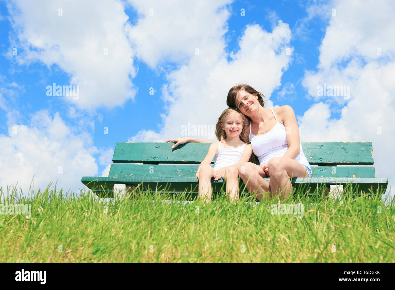 woman with his child sitting on the bench Stock Photo