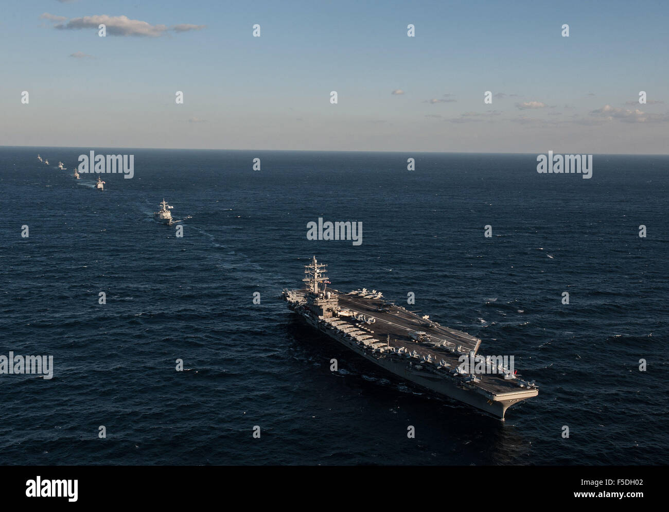 US Navy Nimitz-class aircraft carrier USS Ronald Reagan leads a formation with Republic of Korea naval ships October 28, 2015 off the Korean Peninsula. Stock Photo