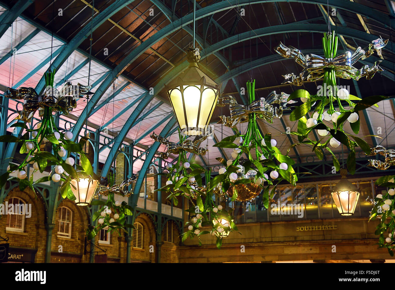 London, UK. 2nd November 2015. First sight of the new Covent Garden Mistletoe Christmas Decorations in London as they are installed in the market. The hanging boughs of mistletoe make a nice change to the giant Xmas tree baubles which have graced the halls of the market for the last couple of years. Credit:  Paul Brown/Alamy Live News Stock Photo