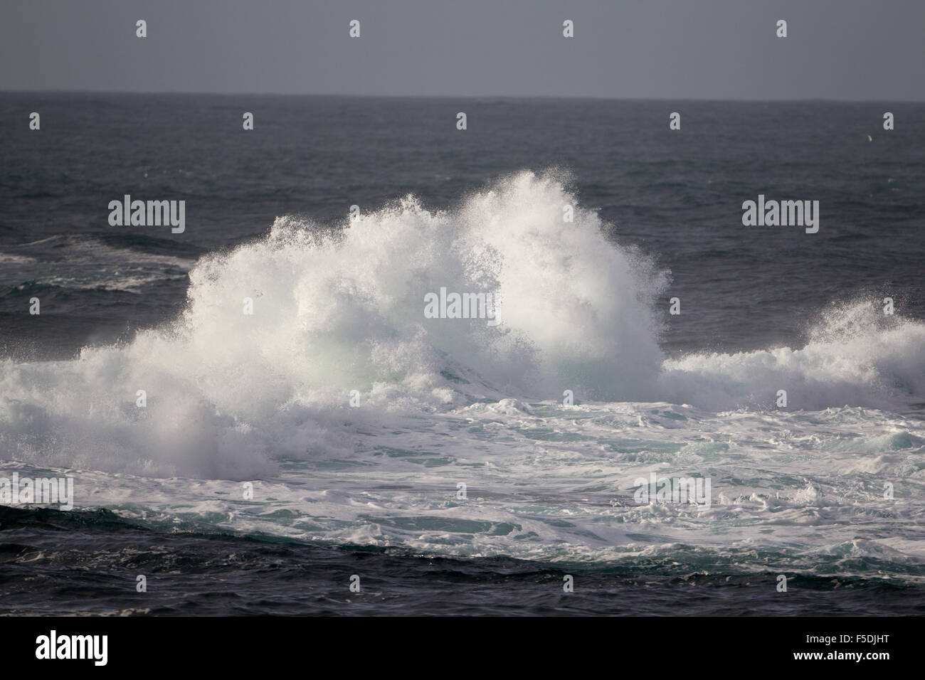 Atlantic Ocean surf breaking on Cowlee rocks at Sennen Cove, Cornwall, United Kingdom Stock Photo