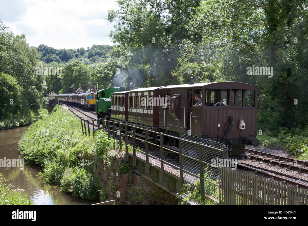Vintage train hauled by a steam locomotive at Consall Station on The Churnet Valley Railway Staffordshire England Stock Photo