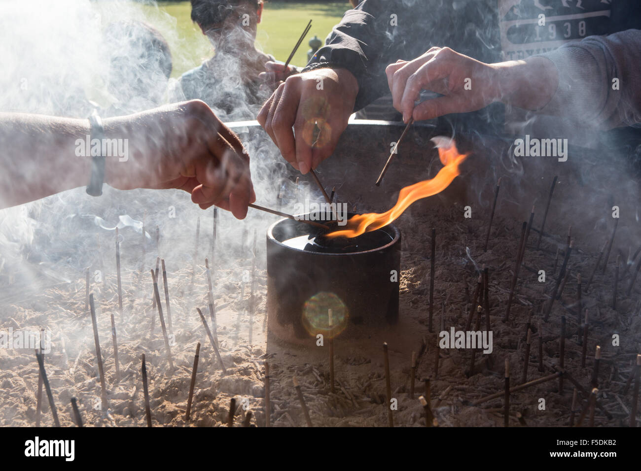3 hands burning incense at temple Stock Photo Alamy