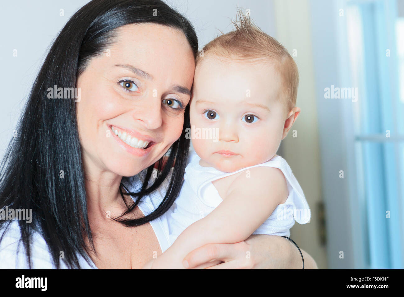 Happy 8 month old baby boy with mother Stock Photo