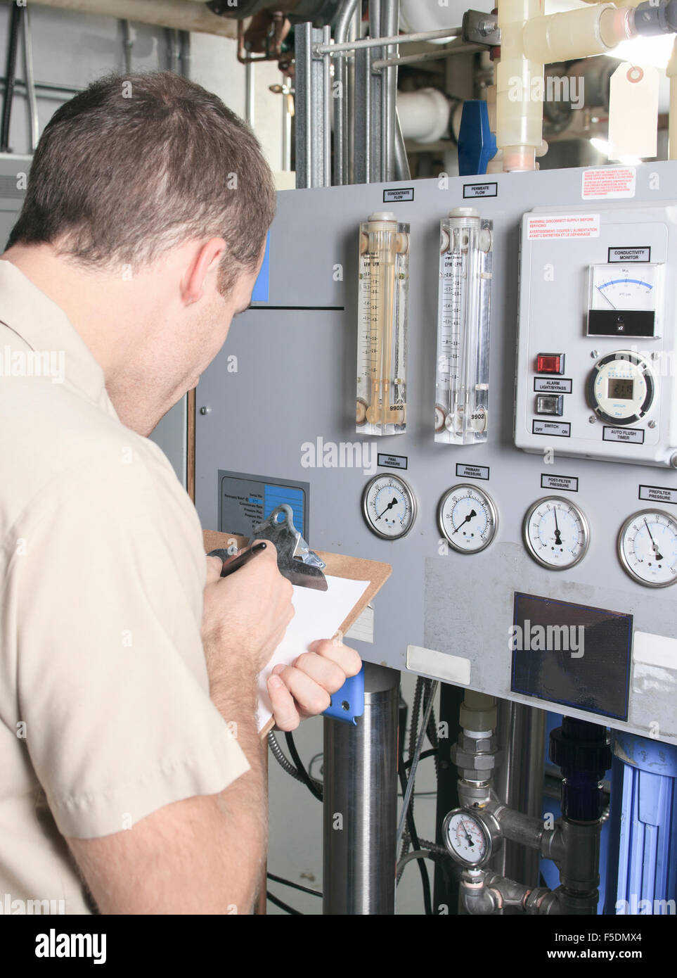Air Conditioner Repair Man at work Stock Photo