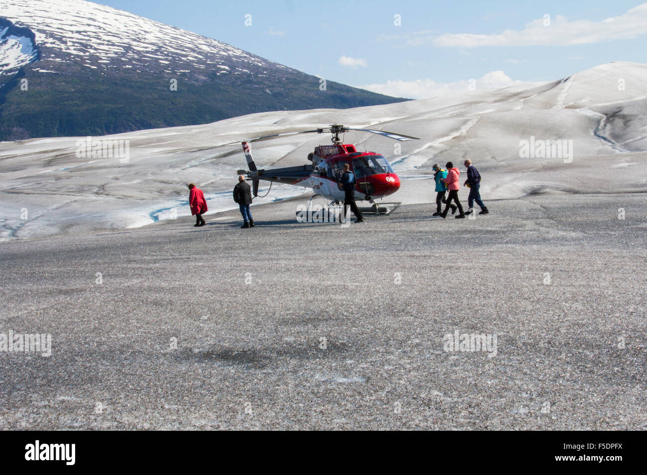 Helicopter flightseeing tours out of Juneau land guests on Taku Glacier, part of the 1,500-sq. mi. Juneau Icefield, Juneau, AK Stock Photo